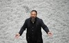 ARCHIV: Chinese artist Ai Weiwei poses with some seeds from his art installation 'Sunflower Seeds' in London (Foto vom 11.10.10). 1979 gruendete Ai mit anderen Kuenstlern die avantgardistische "Sternengruppe", die sich in ihren Arbeiten kritisch mit Zensur auseinandersetzte und bald verboten wurde. 1981 ging Ai nach New York und kehrte erst 1993 wieder in seine Heimat zurueck. In seinen Arbeiten setzte er sich kritisch mit der Kulturgeschichte des Landes, dem zentralistischen politischen System, Globalisierungs- und Demokratisierungsprozessen auseinander. (zu dapd-Text) Foto: Lennart Preiss/AP/dapd