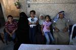 A member of Palestinian prisoner Nasser Nazzal's family shows at a relative's house in the southern Gaza Strip town of Khan Younis on October 15, 2011, as they await his release as part of a deal to secure the exchange of Israeli captive soldier Gilad Shalit. Under a prisoner swap deal signed with Israel, Hamas will free Shalit, held in Gaza since 2006, in exchange for 1,027 Palestinian prisoners. Photo by Ahmed Deeb/wn