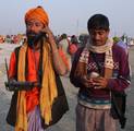 INDIA-SADHU-WITH-TALK-TELEPHONE-GANGASAGAR-MELAIndian Hindu Sadhu Busy to talk on the Telephone at Gangasagar Island, some 150 kms south of Kolkata, on the occasion of Makarsankranti festival in Kolkata on Friday, 14 January 2011. Some three hundred thousand Hindu pilgrims gathered at the Gangasagar Mela (Fair) to take a dip in the Ocean at the confluence of the River Ganges and the Bay of Bengal, on the occasion of Makar Sankranti, a holy day of the Hindu calendar considered to be of great reli