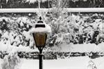 A street light during a snowfall lamppost, street lamp, light standard, or lamp standard is a raised source of light on the edge of a road or walkway, which is turned on or lit at a certain time every night.