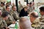 German Chancellor Angela Merkel, center, talks with soldiers in the military camp in Mazar-e-Sharif, Afghanistan, Monday, March 12, 2012.