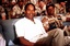 O. J. Simpson sits with a group of servicemen to watch a Thanksgiving Day football game