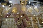 A Palestinian vendor displays a gold jewellery at a jewellery store in the Rafah Refugee Camp, Southern Gaza Strip on September. 19, 2011. Decline in demand for gold in the Palestinian markets due to the high price of $ 50 per gram, this high price in the global gold. ( Photo by Ahmed Deeb/WN)