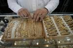 A Palestinian vendor displays a gold jewellery at a jewellery store in the Rafah Refugee Camp, Southern Gaza Strip on September. 19, 2011. Decline in demand for gold in the Palestinian markets due to the high price of $ 50 per gram, this high price in the global gold. ( Photo by Ahmed Deeb/WN)