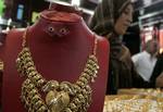 A Palestinian vendor displays a gold jewellery at a jewellery store in the Rafah Refugee Camp, Southern Gaza Strip on September. 19, 2011. Decline in demand for gold in the Palestinian markets due to the high price of $ 50 per gram, this high price in the global gold. ( Photo by Ahmed Deeb/WN)