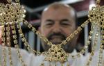 A Palestinian vendor displays a gold jewellery at a jewellery store in the Rafah Refugee Camp, Southern Gaza Strip on September. 19, 2011. Decline in demand for gold in the Palestinian markets due to the high price of $ 50 per gram, this high price in the global gold. ( Photo by Ahmed Deeb/WN)