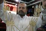 A Palestinian vendor displays a gold jewellery at a jewellery store in the Rafah Refugee Camp, Southern Gaza Strip on September. 19, 2011. Decline in demand for gold in the Palestinian markets due to the high price of $ 50 per gram, this high price in the global gold. ( Photo by Ahmed Deeb/WN)