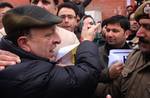 An indian policeman stop Members of civil society hold a protest demonstration while demanding sterilzation of the Dogs in the kashmir valley in Srinagar on 18, February 2012. The protestors also demanding saving Hangul, a symbol of kashmir.