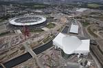 In this photo taken July 14, 2011 and made available by the Olympic Delivery Authority, an aerial view of the Olympic Stadium, back left, and the Aquatics Center, front right, with the Water Polo Arena being developed at the rear is seen at the Olympic Park in London.