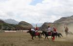 International Lalit and local Drass polo players, in white, compete in a game of polo in Drass, some 160 km east of Kashmiri summer capital Srinagar, on July 10, 2011. The tournament was organised to promote tourism in Jammu and Kashmir as state Chief Minister Omar Abdullah said bringing the valleys onto the international tourist map was among the top priorities of his government.