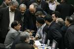 Iranian lawmakers talk in an open session of parliament to debate on impeachment of Transportation Minister Hamid Behbahani, unseen, in Tehran, Iran, Tuesday, Feb. 1, 2011. The Iranian parliament has dismissed the transportation minister and ally of President Mahmoud Ahmadinejad in the wake of several deadly plane crashes in the country.