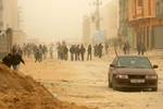 Palestinians walk at a street during cold winds and sand storms in the southern Gaza Strip town of Rafah on February 8, 2012. Photo by Photo by Ahmed Deeb/WN