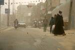 Palestinians walk at a street during cold winds and sand storms in the southern Gaza Strip town of Rafah on February 8, 2012. Photo by Photo by Ahmed Deeb/WN