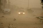 Palestinians walk at a street during cold winds and sand storms in the southern Gaza Strip town of Rafah on February 8, 2012. Photo by Photo by Ahmed Deeb/WN