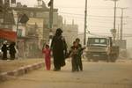 Palestinians walk at a street during cold winds and sand storms in the southern Gaza Strip town of Rafah on February 8, 2012. Photo by Photo by Ahmed Deeb/WN