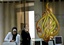 Employees of the Arab news station Al-Jazeera pack equipment and talk on the phone at the station's offices in the West Bank city of Ramallah, Wednesday, July 15, 2009.