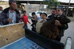 A Palestinian vendor shows his livestock to buyers at market Rafah, southern Gaza Strip, on November 03, 2011 ahead of the Muslim Eid al-Adha festival at the end of the week. Muslims across the world are preparing to celebrate the annual 