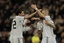 Real Madrid's Karim Benzema from France, left, reacts after scoring against Hercules with fellow team members Esteban Granero, 2nd left, Raul Albiol, 2nd right, and Angel Di Maria from Argentina, right, during a Spanish La Liga soccer match at the Santiago Bernabeu stadium in Madrid, Saturday, March 12, 2011