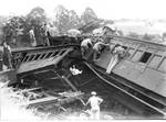 Rescuers search for survivors in the wreckage. The locomotive left the rails on a left-hand curve with a radius of six chains (approximately 120 m (390 ft)) at an estimated speed of 40 mph (64 km/h).