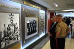 Secretary of the Navy (SECNAV) the Honorable Ray Mabus and Commandant of the Marine Corps Gen. James F. Amos view the Department of the Navy tribute to African American Leadership display at the Pentagon.