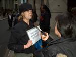 A protester outside AIG's headquarters at the American International Buildling in New York City is interviewed by a news crew. Photographer's blog post about this photo.