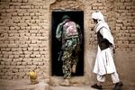 Afghan National Army soldier Taza Khan enters a local elder's home while clearing compounds with U.S. Marines from 3rd Platoon, Lima Company, 3rd Battalion, 3rd Marine Regiment, during Operation Tageer Shamal (Shifting Winds) here, Jan. 4. Over the past few years, Afghan and coalition forces have operated side by side, driving insurgents from the green zones, or populated areas, of the districts in southern Helmand. The few enemy fighters that remain from a decidedly weak insurgency have moved t