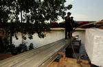 MEMPHIS -- Crewmembers of the Coast Guard Cutter Kankakee embark their river tender by way of a makeshift brow due to flooding near Coast Guard Sector Lower Mississippi River, May 10, 2011. The Coast Guard is supporting the Army Corps of Engineers and several states and local agencies to minimize damage to property, structures and to help save lives from historic flood levels. U.S. Coast Guard photo by Petty Officer 2nd Class Bill Colclough. (1230768) ( Coast Guard Sector Lower Miss. River flood