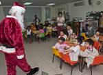 Chief Warrant Officer Marc Lefebvre, dressed as Santa Claus, greets children at Singapore's Child at Street 11 care center,