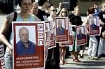 Journalists gather to show their support for the abducted BBC journalist Alan Johnston after claims by a previously unknown group that he had been killed, in front of the European Commission headquarters in Brussels, Monday April 16, 2007. The news corre