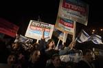 Israelis hold up signs reading in Hebrew: 