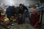 Palestinian workers employed in the warehouses of refrigerators for cheeses in Nusseirat refugee camp in central Gaza Strip on March 5, 2012. While the owners of freezers traders suffer from power cuts and lack of diesel fuel in the Gaza Strip, Ambassador of Egypt to the Palestinian Authority Yasser Othman said there are technical consultations take place between the Palestinian and Egyptian to finalize the final touches to the issue of introduction of fuel through official and legitimate power