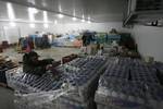 Palestinian workers employed in the warehouses of refrigerators for cheeses in Nusseirat refugee camp in central Gaza Strip on March 5, 2012. While the owners of freezers traders suffer from power cuts and lack of diesel fuel in the Gaza Strip, Ambassador of Egypt to the Palestinian Authority Yasser Othman said there are technical consultations take place between the Palestinian and Egyptian to finalize the final touches to the issue of introduction of fuel through official and legitimate power