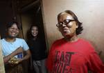 Barack Obama's former nanny Evie, right, shares a light moment with neighbors at her boarding house in Jakarta, Indonesia, Thursday, March 8, 2012. Since being the subject of a recent article by The Associated Press about the struggles of transgender people in this predominantly Muslim nation, the 66-year-old is overwhelmed by her jolt from transgender slum-dweller to local celebrity. TV crews troop in and out of her tiny concrete hovel. Estranged relatives finally want to meet. She even has a p