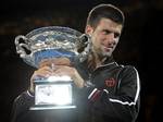 Novak Djokovic of Serbia holds the trophy during the awarding ceremony after defeating Rafael Nadal of Spain in the men's singles final at the Australian Open tennis championship, in Melbourne, Australia, early Monday, Jan. 30, 2012.