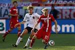 Serbia's Milos Krasic, right, and Germany's Holger Badstuber go for the ball during the World Cup group D soccer match between Germany and Serbia at Nelson Mandela Bay Stadium in Port Elizabeth, South Africa, Friday, June 18, 2010.