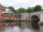 Current Hampton Court Bridge and remains of the former bridge, London. Photograph taken in a public location in the UK of a building on permanent public display, and exempt from copyright under Section 62 of the Copyright Designs & Patents Act 1988 (