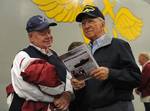 Ken DeHart and his father, retired Air Force Lt. Col. Ken DeHart Sr., read a copy of the ship's newspaper in the hangar bay of the amphibious assault ship USS Bonhomme Richard (LHD 6) while aboard for the Family and Friends Day Cruise 2012.