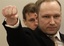 Accused Norwegian Anders Behring Breivik gestures as he arrives at the courtroom, Monday, April 16, 2012, in Oslo, Norway.