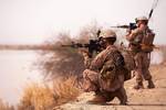 U.S. Marine Lance Cpl. Fabian Aguilar, an assistant gunner with Weapons Platoon, Alpha Company, 1st Light Armored Reconnaissance Battalion and 21-year-old native of Aurora, Colo., and Lance Cpl. Michael Fitch II, a point man with Weapons Plt., Alpha Co., 1st LAR, sight in while posting security during a patrol near the Helmand River here, March 24, 2012. The patrol was one of many missions the platoon has conducted since deploying to southern Helmand in October 2011. Marines with Weapons Plt. ha