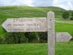 Pennine Way sign Malham Cove is a natural limestone formation 1 km north of the village of Malham, North Yorkshire, England.