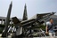 A visitor walks near the mock North Korean Scud-B missile, extreme left, and other South Korean missiles on display at Korea War Memorial Museum in Seoul, South Korea, Monday, May 25, 2009.