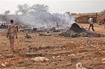 This photo of Saturday, April 14, 2012, shows the aftermath of a bombing by the Sudanese Air Force in Bentiu, South Sudan. Two Sudanese Sukhoi fighters dropped 6 bombs in the Bentiu area, killing five and wounding four others.