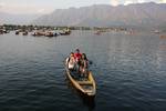 Kashmiris row boats with Foreign tourists Dal Lake in Srinagar on June 22, 2011. The tourism industry is hoping that the cool summer weather will herald a renewal of tourists to the scenic region after last year's civil unrest drove both domestic Indian and foreign tourists out of the valley.