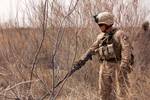 U.S. Marine Lance Cpl. John Amore, a team leader and mortar man with Weapons Platoon, Alpha Company, 1st Light Armored Reconnaissance Battalion, sweeps for caches and possible improvised explosive devices near the Helmand River, March 24, 2012. (U.S. Marine Corps photo by Cpl. Alfred V. Lopez/Released)