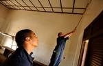 MALABO, Guinea (July 10, 2005) Seaman Jason West watches Petty Officer 2nd Class (OS) Ian McGoohan paint a classroom at a school in Malabo, Equatorial Guinea USCG photo by PA2 Andrew Shinn. (102768) ( CGC BEAR IN GUINEA (FOR RELEASE) )