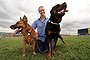 Photo by Jeffrey Chan.  RSPCA ACT Senior Behavioural Trainer Frances Marsh with Sandy the Shepherd Cross and Harry the Rottweiler