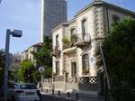 An eclectic house in Neve Tzedek with a skyscraper in the background. Tel Aviv is divided into nine districts that have formed naturally over the city's short history. The oldest of these is Jaffa, the ancient port city out of which Tel Aviv grew.