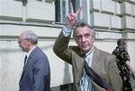 Defiant former Soviet vice-president Gennady Yanayev flashes a victory sign in this Tuesday May 18, 1993 file photo as he and the former KGB chairman Vlaimir Kryuchkov, left, emerge from the Moscow court building. Russia's Communist Party says Gennady Yanayev, a coup plotter who briefly declared himself president of the Soviet Union, replacing Mikhail Gorbachev, died Friday Sept. 24, 2010 at age 73.