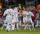 Real Madrid's players celebrate after Real Madrid's Portuguese forward Cristiano Ronaldo, center, scored against Lyon during their Group D Champions League soccer match, at Gerland Stadium, in Lyon, central France, Wednesday, Nov. 2, 2011.