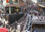 Staircase between levels at Cabot Circus shopping centre, Bristol, England, United Kingdom. A sitting area is provided on the right of the staircase proper.